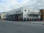 Customers line up in front of one of Kodiak's two movie theaters, Alaska