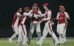 Kings XI Punjab captain Adam Gilchrist, center, celebrates with teammates the dismissal of Delhi Daredevils' Virender Sehwag during an Indian Premier League cricket match in New Delhi, India, Saturday, April 23, 2011.