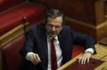 Greek Prime Minister Antonis Samaras gestures to a colleague at the Parliament after winning a vote of confidence in Athens, late Sunday July 8, 2012. The new three-party coalition government has won a vote of confidence in the Greek Parliament early Monday. All 179 deputies of the three parties supporting the government _ conservative New Democracy, the socialist PASOK and the moderate leftist Democratic Left _ have voted in favor.