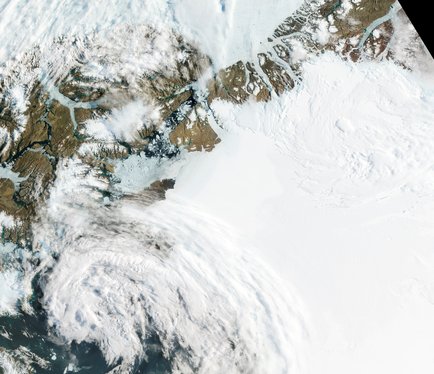 The Petermann Glacier grinds and slides toward the sea along the northwestern coast of Greenland, terminating in a giant floating ice tongue.