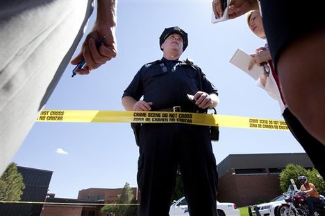 Lt. H.D. Gidden speaks briefly to the media outside Gateway High School where witnesses were brought for questioning after a gunman opened fire at the midnight premiere of the Dark Knight Rises Batman movie Friday, July 20, 2012 in Aurora, Colo.