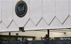 A worker repairs the damaged gate of the main entrance of the US embassy in the capital San'a, Yemen