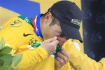 Thomas Voeckler of France kisses the overall leader's yellow jersey on the podium of the 18th stage of the Tour de France cycling race over 200.5 kilometers (124.6 miles) starting in Pinerolo, Italy, and finishing on Galibier pass, Alps region, France, Thursday July 21, 2011.