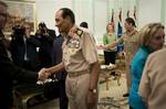 US Secretary of State Hillary Rodham Clinton, back center, watches as Field Marshal Hussein Tantawi, second left, greets members of the American delegation before a meeting at the Ministry of Defense