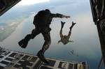 U.S. Air Force Airmen from the 720th Special Tactics Group out of Hurlburt Field, Fla., jump out of a C-130J Hercules aircraft during water rescue training above Choctawhatchee Bay, over the Destin coastline in Florida Oct. 3, 2007.