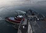 Tugboats assist the Whidbey Island-class amphibious dock landing ship USS Gunston Hall (LSD 44)