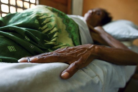 File - HIV/AIDS patient lies in bed at the Bairo Pite clinic for comprehensive community health service, Dili, East Timor.