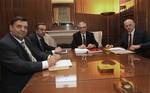 Greek Prime Minister Loukas Papademos,center, leader of the Socialist Party PASOK George Papandreou, right, leader of the conservative Party New Democracy Antonis Samaras, 2nd left and the leader of the right wing LAOS party George Karadjaferis enter the meeting room at Maximos mansion in Athens on Wednesday Feb.8, 2012. After three days of delays, Greek coalition leaders began crucial debt talks Wednesday with the prime minister to review a draft deal on steep cutbacks demanded by creditors in