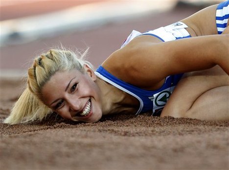 FILE- Greece's Voula Papachristou lands in the sand after her jump at the Women's Triple Jump final at the European Athletics Championships in Helsinki, Finland, in this file photo dated Friday, June 29, 2012.