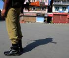 Indian paramilitary troops stand guard infront of closed shops during a strike in Srinagar on 28, July 2012.The call for strike was given hardline separatist leader Syed Ali Geelani Life was adversely affected in other major towns of the valley on Saturday following a shutdown called by the separatists to protest the killing of a 21-year-old youth Hilal Ahmad Dar. Dar was allegedly killed in an army firing in Bandipora district on late July 24, local media reported.