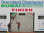 Evans Kiprop Cheruiyot of Kenya crosses the finish line in second place behind David Barmasai Tumo, also of Kenya, in the Dubai Marathon 2011 held in Dubai, UAE, on Friday, Jan. 21, 2011.