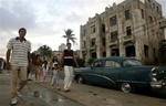 File - Six Cubans, part of a group who were returned to Cuba in January, walk towards the U.S. mission for a meeting in Havana, Monday, Dec. 18, 2006.