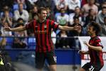 Manchester City's Edin Dzeko, left, celebrates with team mate David Silva after scoring a goal against Bolton during their English Premier League soccer match at the Reebok Stadium, Bolton, England, Sunday Aug. 21, 2011.