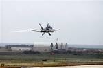 An F-18 Hornet jet fighter lands at the Nato airbase of Birgi, near Trapani, Sicily, Italy, Saturday, March 19, 2011. Six Danish F-16 fighter jets landed Saturday at the U.S. air base in Sicily, and U.S., Canadian and Spanish F-18s flew into the region as the international military buildup mounted in Italy for action against Libya. Italy has offered the use of seven military bases to help enforce the U.N.-authorized no-fly zone over Libya and protect Libyan civilians from Moammar Gadhafi's troop