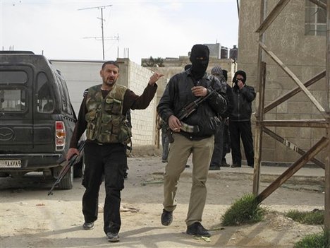 In this Sunday, April 1, 2012 photo, Free Syrian Army fighters are seen in a neighborhood of Damascus, Syria.