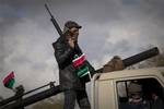 Libyan rebels patrol the center of Benghazi, eastern Libya, Sunday, March 20, 2011. A senior Pentagon official says U.S. and allied attacks in Libya have been very effective in degrading Moammar Gadhafi's ability to threaten planes enforcing a no-fly zone over the North African country.