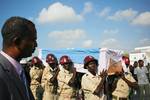 SOMALIA, Mogadishu: In a photograph released by the African Union-United Nations Information Support Team 25 March, the casket containing the body of fomer Somali president Abdullahi Yusuf Ahmed who died aged 77 on Friday at a hospital in the Gulf State of Abu Dhabi is carried from an aircraft at Mogadishu International Airport during a ceremony ahead of his burial. AU-UN IST PHOTO / STUART PRICE.