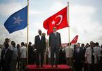 SOMALIA, Mogadishu: In a handout photograph released by the African Union-United Nations Information Support Team 19 August, Somali President Sheik Sharif Sheik Ahmed and Turkish Prime Minister Recep Tayyip Erdogan listen to their countries national anthems following Erdogan's arrival at Aden Abdulle International Airport of on an official visit to Somalia. AU-UN IST PHOTO / STUART PRICE.