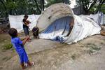 File - Internally displaced persons (IDPs) in Timor-Leste, seen here erecting a UN Refugee Agency (UNHCR) tent, 29 December, 2007.