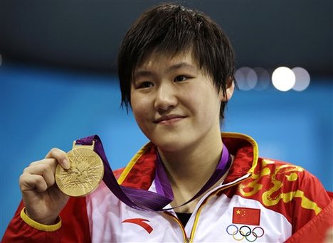 China's Ye Shiwen poses with her gold medal for the women's 200-meter individual medley swimming final at the Aquatics Centre in the Olympic Park during the 2012 Summer Olympics in London, Tuesday, July 31, 2012.