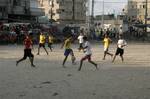 Palestinian youths playing football during a local match a little before sunset in Rafah refugee camp in the southern Gaza Strip on July 28, 2012. Palestinians organize Ramadan Olympics in conjunction with the ongoing Olympic Games in London, while Muslims around the world abstain from food, drink and sex from sunrise to sunset during Ramadan the holiest month in the Islamic calendar.Photo by Ahmed Deeb / WN