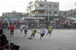 Palestinian youths playing football during a local match a little before sunset in Rafah refugee camp in the southern Gaza Strip on July 28, 2012. Palestinians organize Ramadan Olympics in conjunction with the ongoing Olympic Games in London, while Muslims around the world abstain from food, drink and sex from sunrise to sunset during Ramadan the holiest month in the Islamic calendar.Photo by Ahmed Deeb / WN