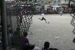 Palestinian youths playing football during a local match a little before sunset in Rafah refugee camp in the southern Gaza Strip on July 28, 2012. Palestinians organize Ramadan Olympics in conjunction with the ongoing Olympic Games in London, while Muslims around the world abstain from food, drink and sex from sunrise to sunset during Ramadan the holiest month in the Islamic calendar.Photo by Ahmed Deeb / WN