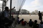 Palestinian youths playing football during a local match a little before sunset in Rafah refugee camp in the southern Gaza Strip on July 28, 2012. Palestinians organize Ramadan Olympics in conjunction with the ongoing Olympic Games in London, while Muslims around the world abstain from food, drink and sex from sunrise to sunset during Ramadan the holiest month in the Islamic calendar.Photo by Ahmed Deeb / WN