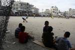 Palestinian youths playing football during a local match a little before sunset in Rafah refugee camp in the southern Gaza Strip on July 28, 2012. Palestinians organize Ramadan Olympics in conjunction with the ongoing Olympic Games in London, while Muslims around the world abstain from food, drink and sex from sunrise to sunset during Ramadan the holiest month in the Islamic calendar.Photo by Ahmed Deeb / WN