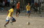 Palestinian youths playing football during a local match a little before sunset in Rafah refugee camp in the southern Gaza Strip on July 28, 2012. Palestinians organize Ramadan Olympics in conjunction with the ongoing Olympic Games in London, while Muslims around the world abstain from food, drink and sex from sunrise to sunset during Ramadan the holiest month in the Islamic calendar.Photo by Ahmed Deeb / WN