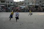 Palestinian youths playing football during a local match a little before sunset in Rafah refugee camp in the southern Gaza Strip on July 28, 2012. Palestinians organize Ramadan Olympics in conjunction with the ongoing Olympic Games in London, while Muslims around the world abstain from food, drink and sex from sunrise to sunset during Ramadan the holiest month in the Islamic calendar.Photo by Ahmed Deeb / WN