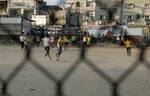 Palestinian youths playing football during a local match a little before sunset in Rafah refugee camp in the southern Gaza Strip on July 28, 2012. Palestinians organize Ramadan Olympics in conjunction with the ongoing Olympic Games in London, while Muslims around the world abstain from food, drink and sex from sunrise to sunset during Ramadan the holiest month in the Islamic calendar.Photo by Ahmed Deeb / WN