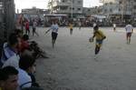 Palestinian youths playing football during a local match a little before sunset in Rafah refugee camp in the southern Gaza Strip on July 28, 2012. Palestinians organize Ramadan Olympics in conjunction with the ongoing Olympic Games in London, while Muslims around the world abstain from food, drink and sex from sunrise to sunset during Ramadan the holiest month in the Islamic calendar.Photo by Ahmed Deeb / WN