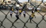 Palestinian youths playing football during a local match a little before sunset in Rafah refugee camp in the southern Gaza Strip on July 28, 2012. Palestinians organize Ramadan Olympics in conjunction with the ongoing Olympic Games in London, while Muslims around the world abstain from food, drink and sex from sunrise to sunset during Ramadan the holiest month in the Islamic calendar.Photo by Ahmed Deeb / WN