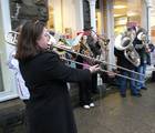 A brass band playing Christmas carols.