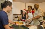 Rear Admiral Frank Ponds, right, commander, Navy Region Hawaii, Naval Surface Group Middle Pacific, his wife Carol Ponds, center, help serve a Christmas morning breakfast.