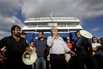 Members of PAME, a communist party-backed labor group chant slogans as they blockade the entrance of a ferry in Piraeus Port, near Athens, Greece, on Wednesday, June 23, 2010. Striking port workers were preventing hundreds of passengers from boarding ferries heading from Greece's main port of Piraeus to Aegean holiday islands Wednesday, despite a court order declaring their strike illegal. The scenes at Piraeus come as Greece's main tourist season gets into full swing and will horrify those who