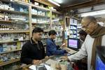 An elderly Indian customer buys medicine at a chemist shop in New Delhi, India, Saturday, Dec. 25, 2004. On Jan. 1, 2005. India faces a deadline set by the World Trade Organization to overhaul its patent laws, ending decades of policies that allowed Indian firms from pharmaceutical giants to tiny technology companies to make less costly versions of expensive Western products.