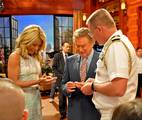 Capt. Mark Genung presents Regis Philbin and Kelly Ripa with command coins during a taping of the Regis & Kelly Show.