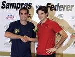 This Nov. 23, 2007 file photo shows tennis players Roger Federer of Switzerland, right, and Pete Sampras of the United States, posing at a news conference at the Venetian Macao Resort in Macau, the day before a friendly match. After so many tournaments and so many years of being the man everyone was after, Roger Federer enters 2009 as the one doing the pursuing. Federer is chasing Pete Sampras, hoping to tie and then break his record of 14 Grand Slam titles. And, suddenly, Federer is chasing Raf