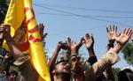 A Hindu man, carrying a flag with a picture of Lord Krishna, shouts slogans during a religious procession ahead of Janmashtami celebrations in Srinagar August 9, 2012. Janmashtami, the birth anniversary of Lord Krishna, falls on Friday.