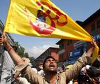 A Hindu man, carrying a flag with a picture of Lord Krishna, shouts slogans during a religious procession ahead of Janmashtami celebrations in Srinagar August 9, 2012. Janmashtami, the birth anniversary of Lord Krishna, falls on Friday.