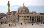 In this Feb. 22, 2006 file photo, Iraqis walk past the damaged al-Askari mosque following an explosion in Samarra, 95 kilometers (60 miles) north of Baghdad, Iraq. Iraqi police say a suicide bomber struck Shiite pilgrims near a shrine in Samarra north of Baghdad Saturday Feb. 12, 2011. that has been a flash-point in sectarian strife killing and wounding scores of people.