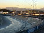 The Los Angeles River is extensively channelized with concrete embankments. River engineering is the process of planned human intervention in the course, characteristics or flow of a river with the intention of producing some defined benefit.