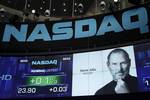 A photo of Apple co-founder Steve Jobs is displayed as a tribute, Thursday, Oct. 6, 2011 at Nasdaq in New York. Jobs died Wednesday at age 56 after a long battle with cancer. Apple shares are listed on Nasdaq. (AP Photo/Mark Lennihan)