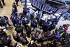 Traders gather at the post that handles Global Payments Inc. on the floor of the New York Stock Exchange, Monday, April 2, 2012, in New York. Visa Inc. has dropped Global Payments, the card processor involved in a massive data breach, from its registry of providers that meet data security standards, but may reinstate it after a new compliance report.