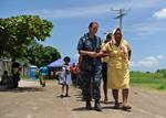 Hospital Corpsman 2nd Class Amanda Johnson, from Bedford, Penn., helps a Salvadoran woman