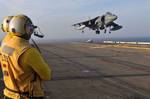 Aviation Boatswain's Mate 2nd Class (Handling) Manuel Arias watches as an AV-8B Harrier from Marine Attack Squadron (VMA) 214 lands aboard the forward deployed amphibious assault ship USS Essex (LHD 2).