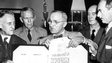 US President Harry S Truman holds up the official Japanese document of surrender with Emperor Hirohito's signature