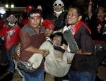 Protesters help carry Hiro Muramoto, a 43-year old Tokyo-based Japanese national who worked as a TV cameraman for Reuters, after he was shot during a clash between protesters and Thai soldiers Saturday, April 10, 2010 in Bangkok, Thailand. Thailand's government said five soldiers and 13 civilians, including Muramoto, have died in the worst violence in Bangkok since more than four dozen people were killed in an antimilitary protest in 1992. Muramoto was married with two children, according to Tho